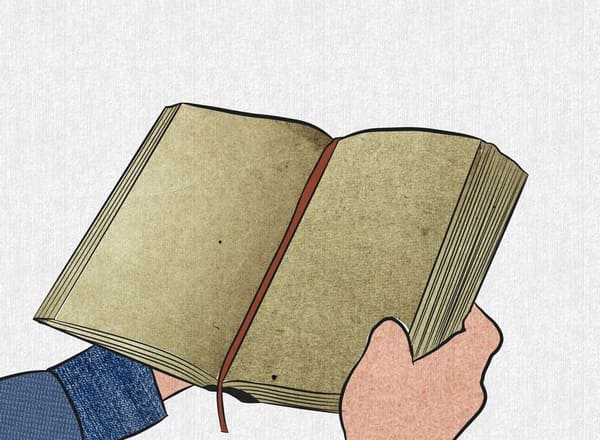 Enfant tenant dans ses mains un livre d'enfant sur l'Islam.